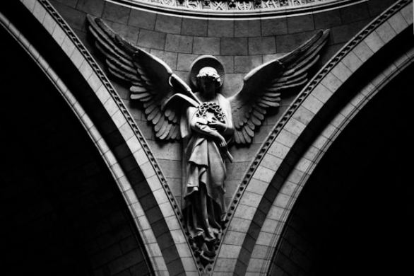 a stone angel holding a wreath of thorns
